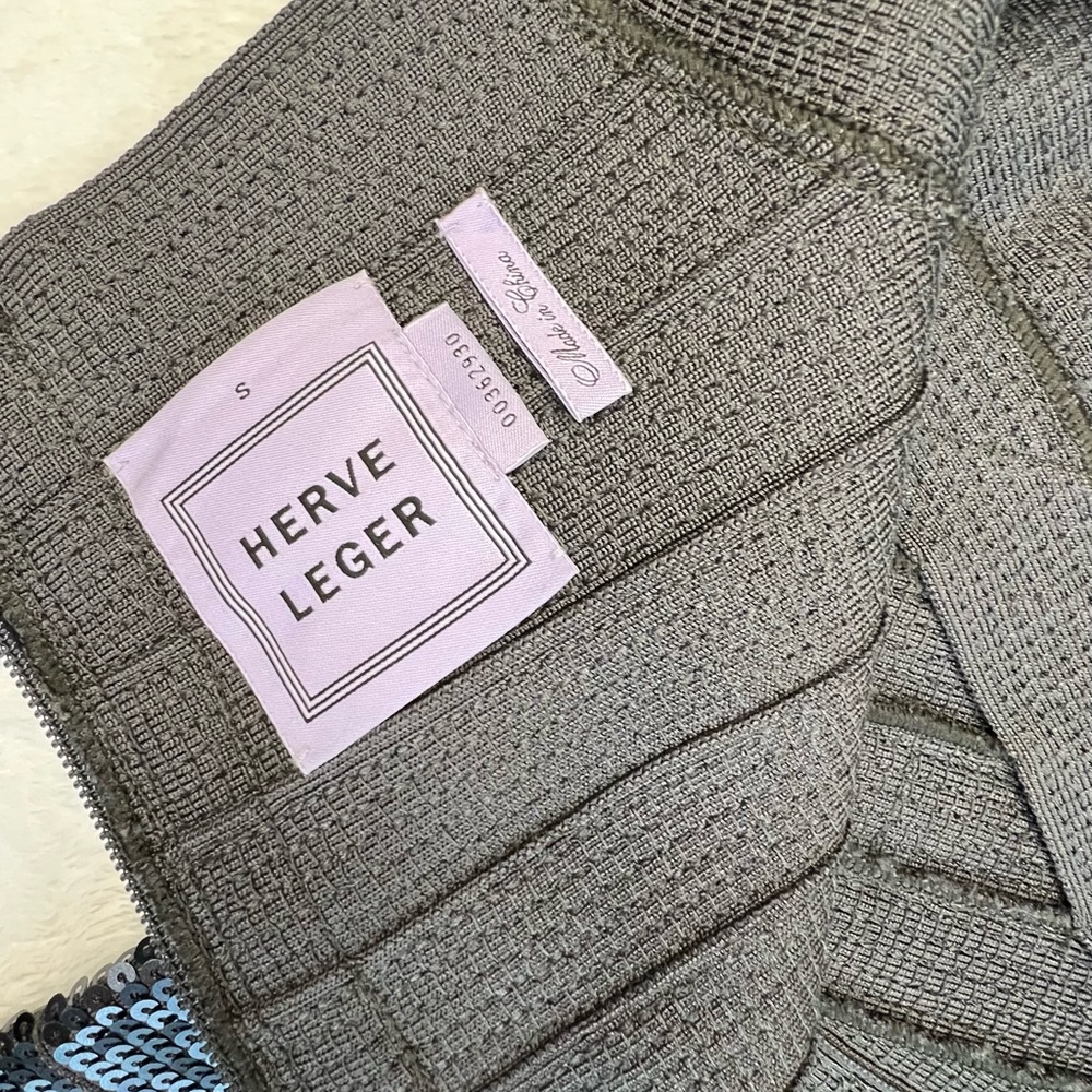 This high-shine bodycon dress features a sleeveless silhouette. Herve Leger!